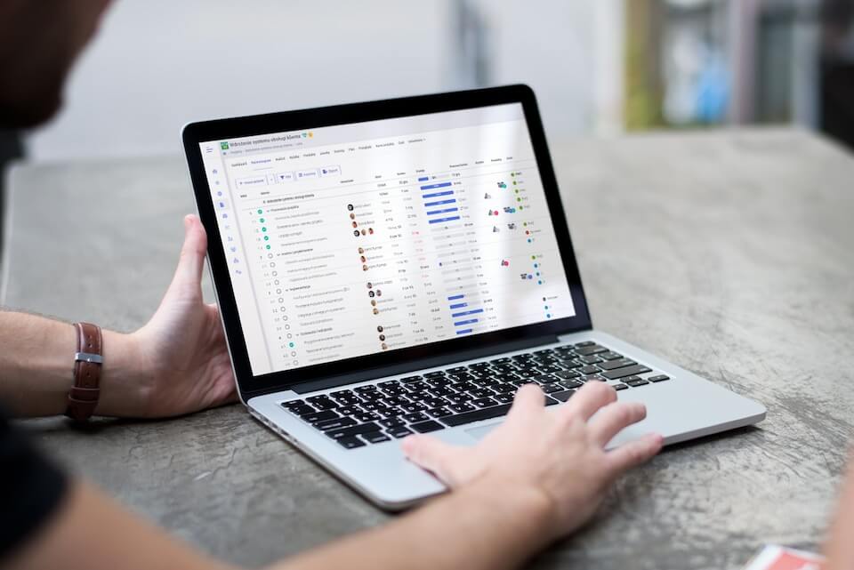 Mężczyzna prezentujący sytem na laptopie