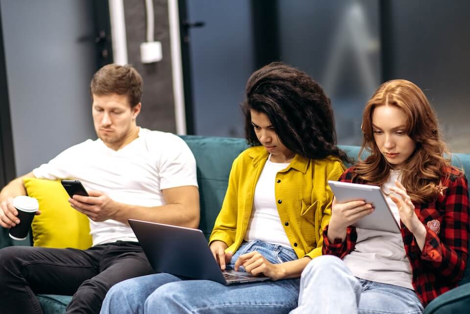Grupa osób korzystających z Internetu na różnych urządzeniach